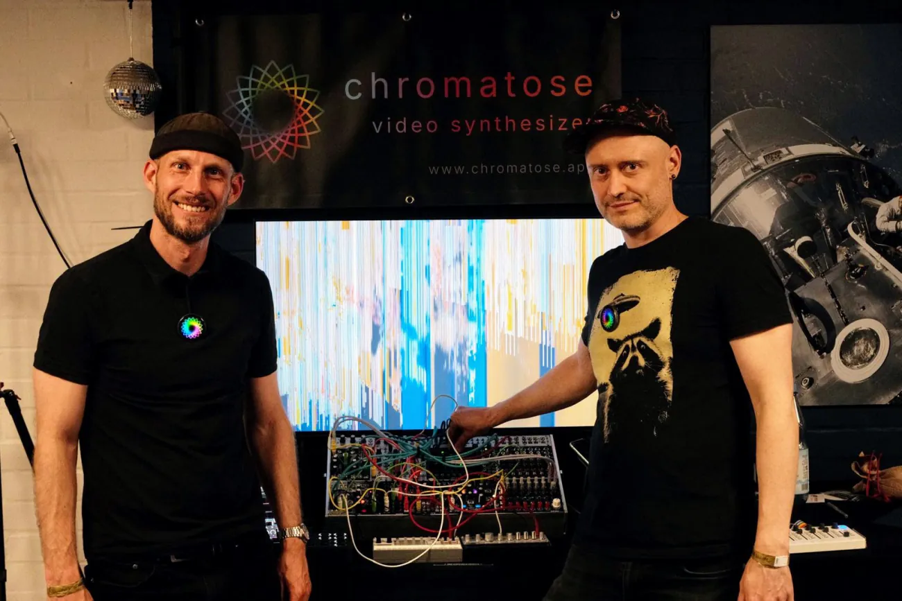 The Chromatose booth at Superbooth 2026, with a Eurorack modular synthesizer in front of a screen showing live generated visuals